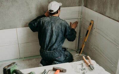 Professional handyman performing Tiles installation on wall